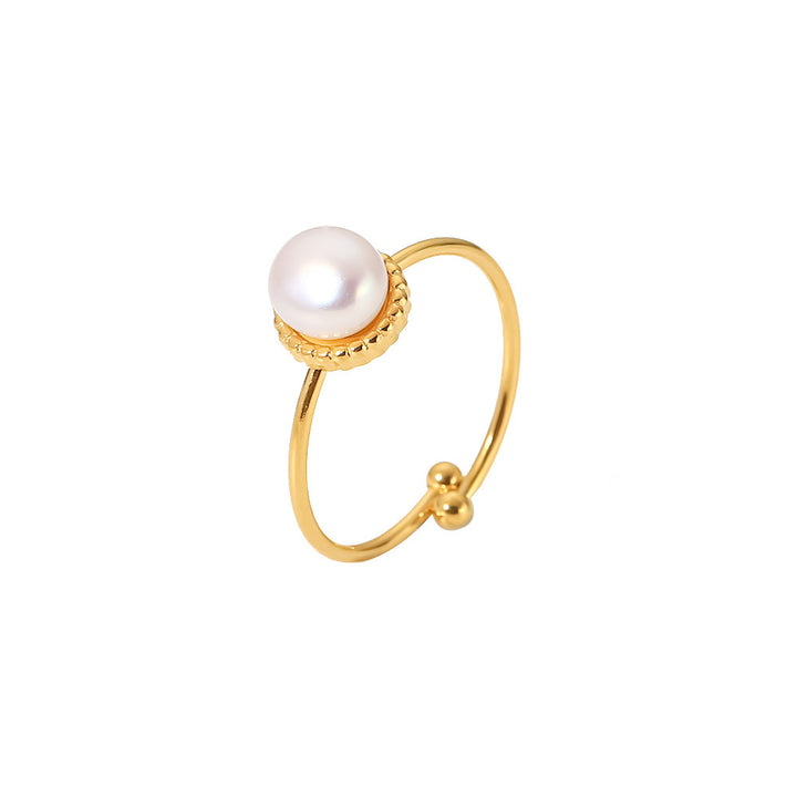 Gold ring with a pearl on a white background