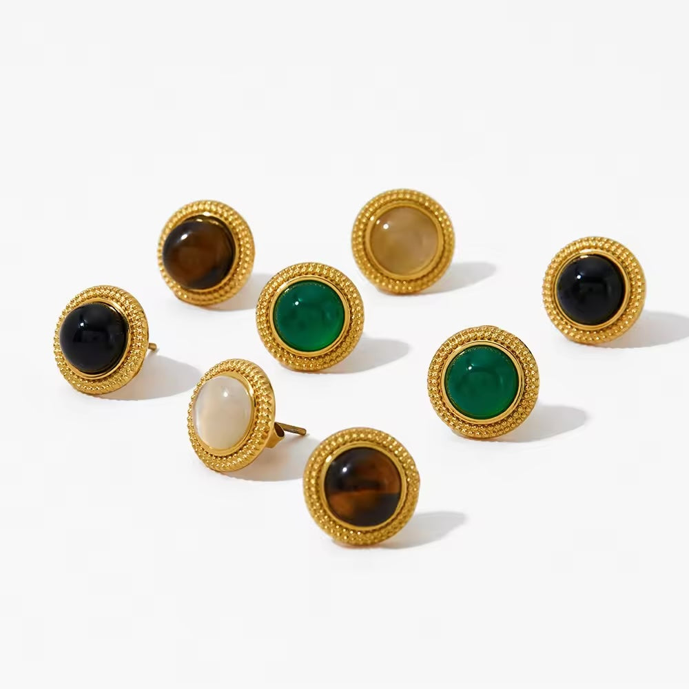 A collection of round stud earrings with natural stone embellishments, in rose gold finish.
