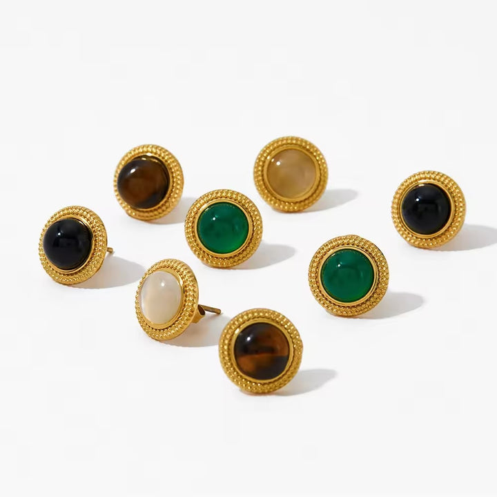 A collection of round stud earrings with natural stone embellishments, in rose gold finish.